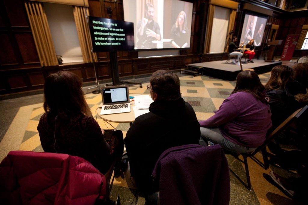 CART Captioning is displayed as Nyle DiMarco signs to a large audience in conjunction with a Distinguished Lecture Series event at UW-Madison
