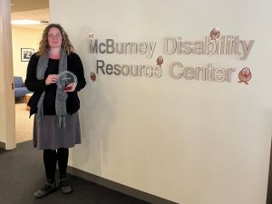 Maria Dahman posing with her access award at the McBurney Disability Resource Center