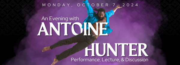 Antoine Hunter leaping high and horizontally with arms outstretched (against a purple cloud background)