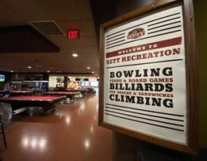 A sign at the entrance to The Sett Rec space at Union South for bowling, billiards, & climbing